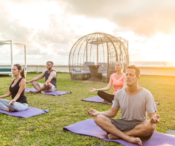 Happy family mother father and 10 year old boy doing yoga together at home family wellness bonding